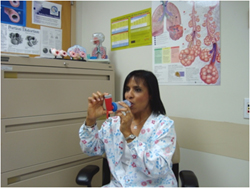 A woman demonstrating the use of an inhaler to treat asthma.
